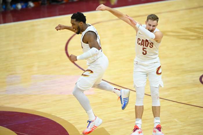 Dec 18, 2023; Cleveland, Ohio, USA; Cleveland Cavaliers guard Donovan Mitchell (45) and guard Sam Merrill (5) celebrate in overtime against the Houston Rockets at Rocket Mortgage FieldHouse.
